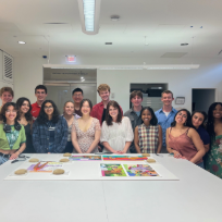 students pose with chitra ganesh's artwork