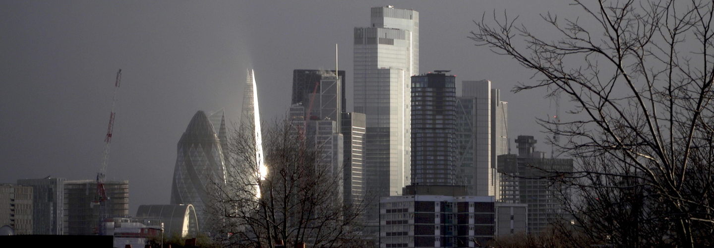 light reflects on the glass buildings of London's skyline