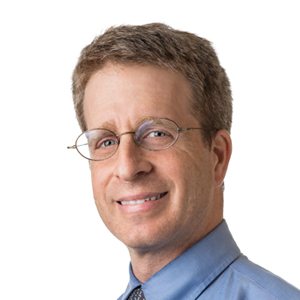 headshot of blonde man in glasses and blue button-down 