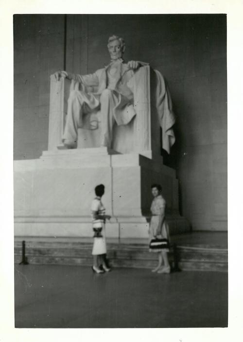 two women standing in front of the Lincoln Memorial
