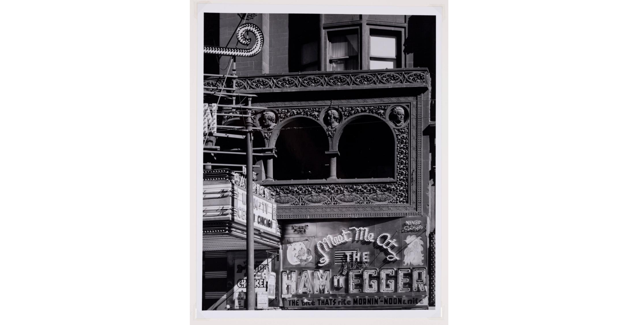 black and white photo of architectural detail behind theater marquee