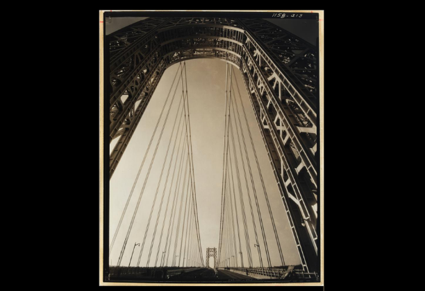 Upward view of suspension cables on bridge from beneath towering pylons
