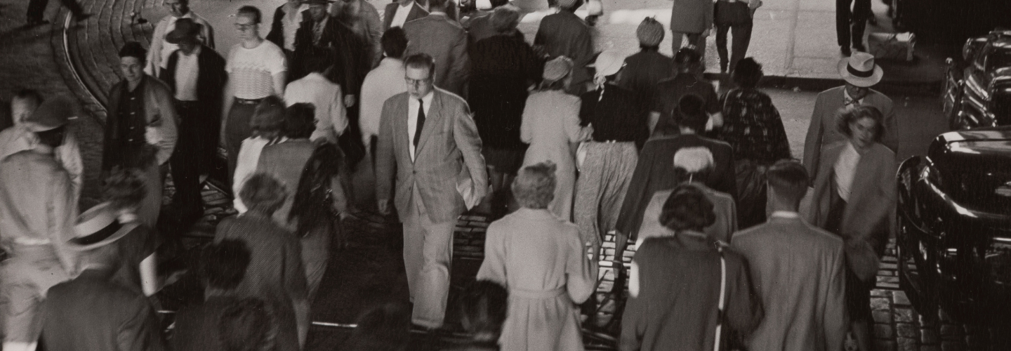 man walking to El train.