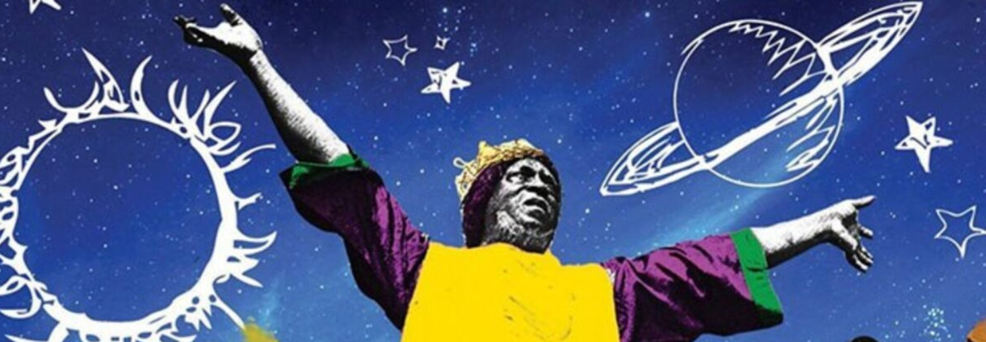 Wearing a yellow and purple tunic and with arms out-streched, Sun Ra is encircled by a group of musicians, against a bright blue backdrop decorated with celestial drawings.