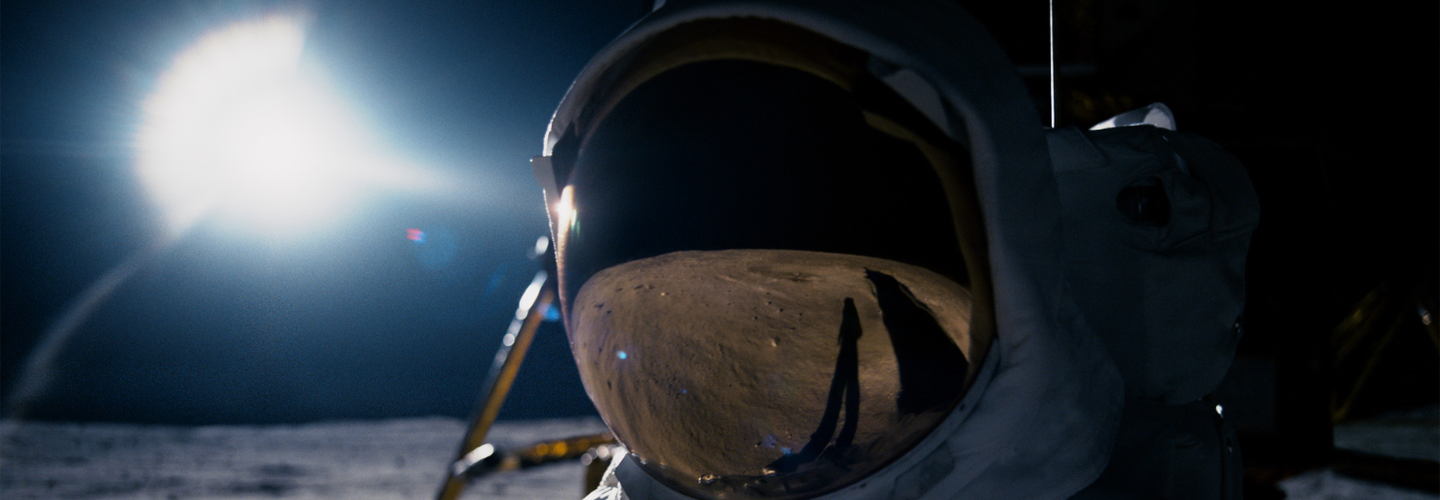 The moon reflected in an astronaut's helmet