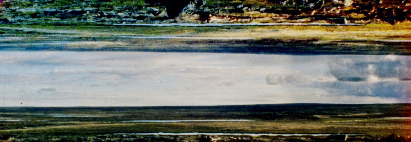 Film stills of a wide landscape mirrored above and below and a blue orb