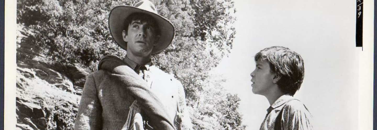 Black and white photo of Anthony Perkins in a hat and a child