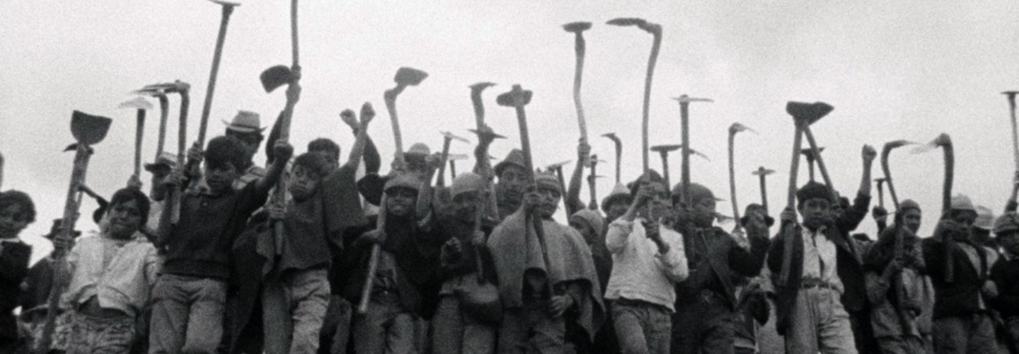 A group raise plows and hoes in defiance