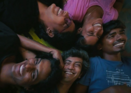 Five people with medium-dark skin tone recline, smiling, enjoying the company. 
