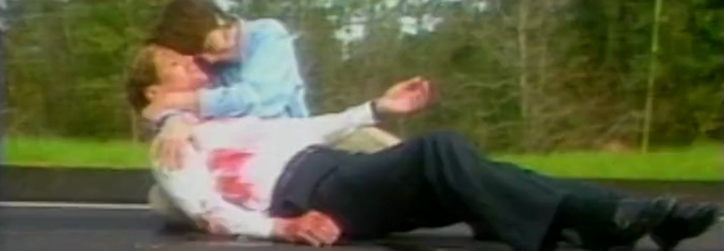 A woman cradles a bloodstained man on a Florida highway