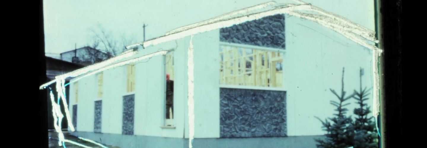 An etched and manipulated 16mm film still depicting the frame of a house under construction.