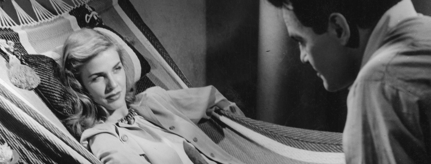 A film still depicting a scene from the film DREAMS THAT MONEY CAN BUY featuring a reclining female figure and a seated male figure.