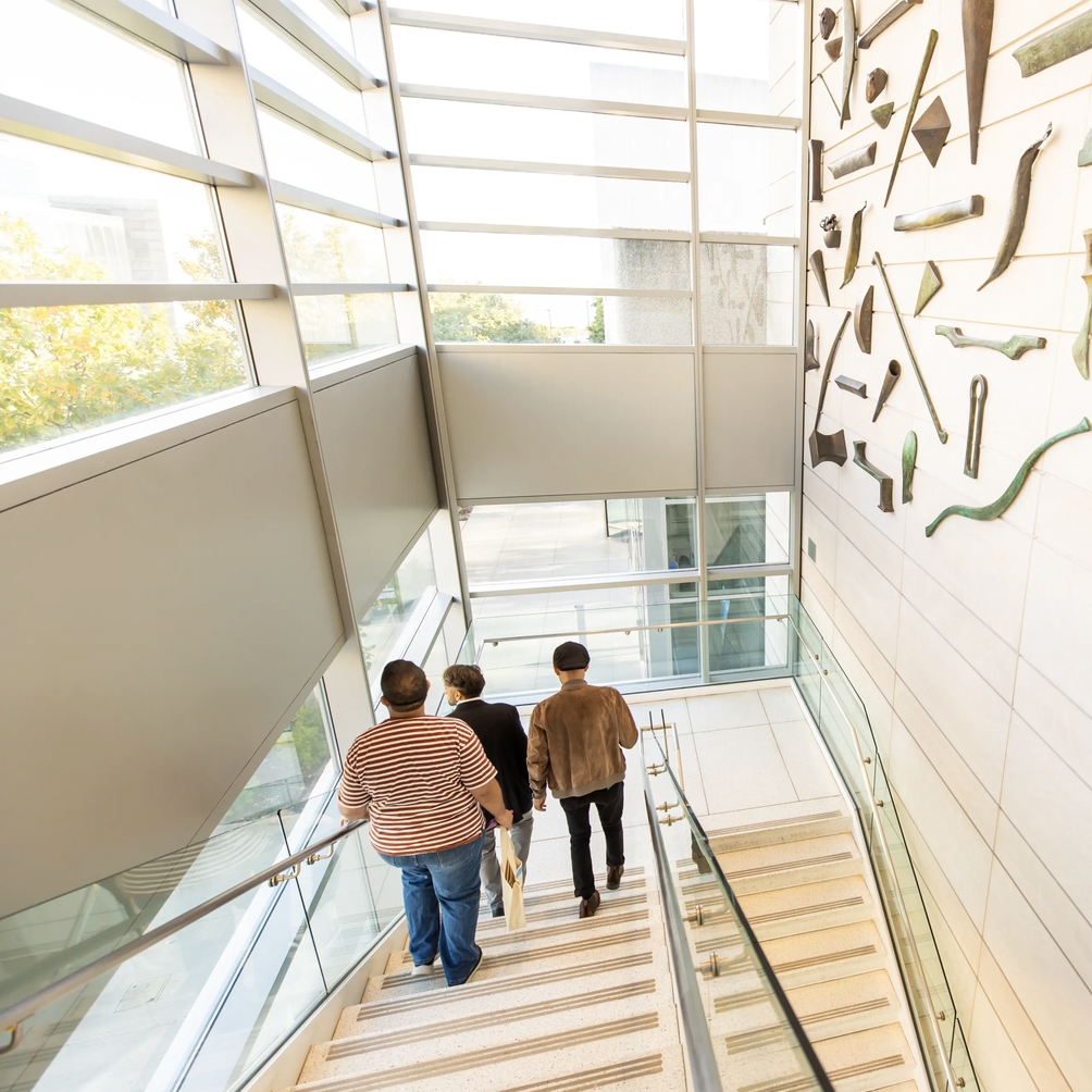 people walk down stairs in Block Museum atrium